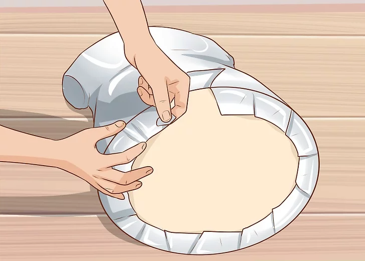 Attach the cardboard base to the mannequin’s bottom